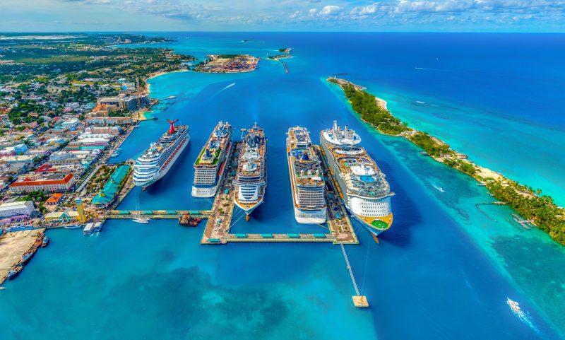 5 cruise ships docked at port in Nassau, Bahamas. You can find great travel deals on cruises!