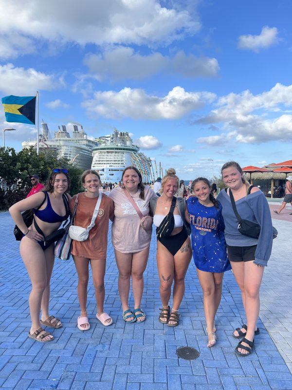 All 6 girls on Cococay in the Bahamas, with the ship in the background.