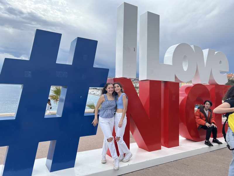 Kaylee and her friend in front of the #ilovenice sign on the Boulevard des Anglais in Nice, France.