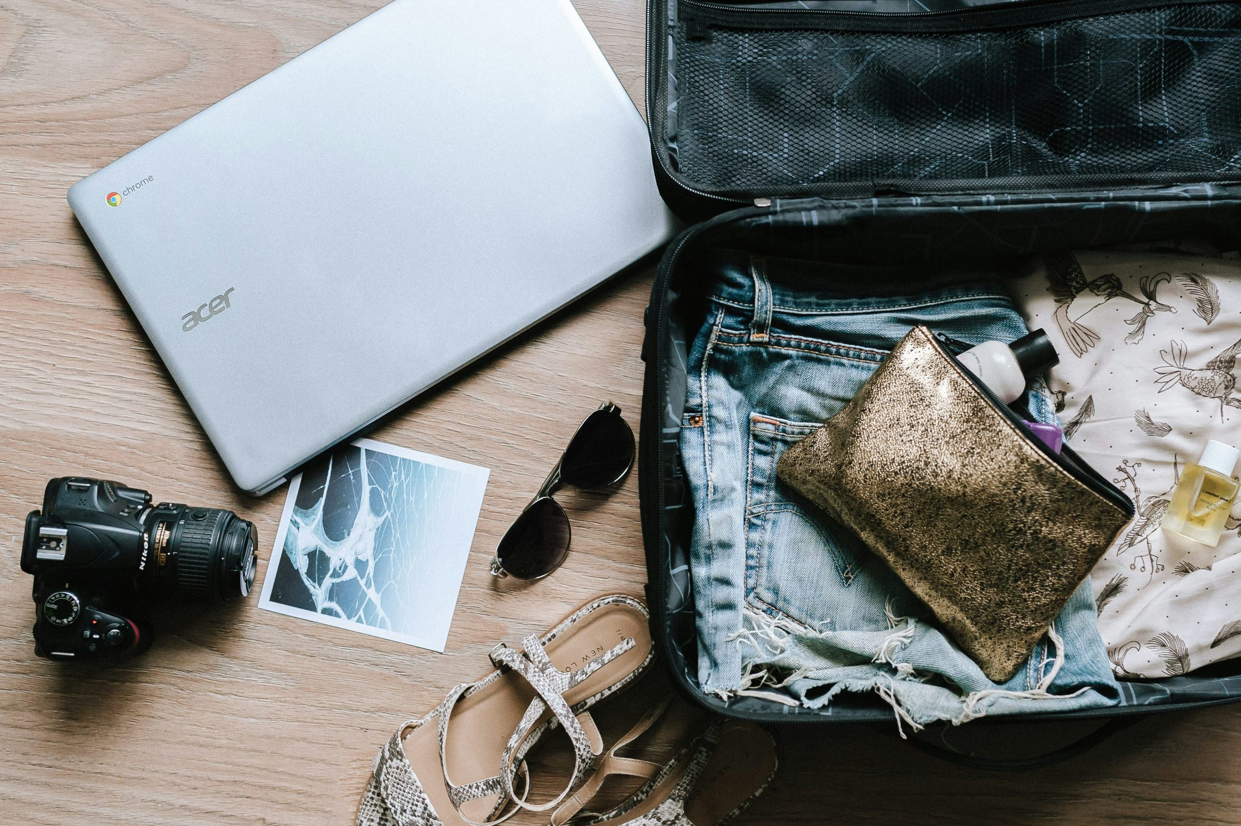 Packing: suitcase, sunglasses, camera, laptop