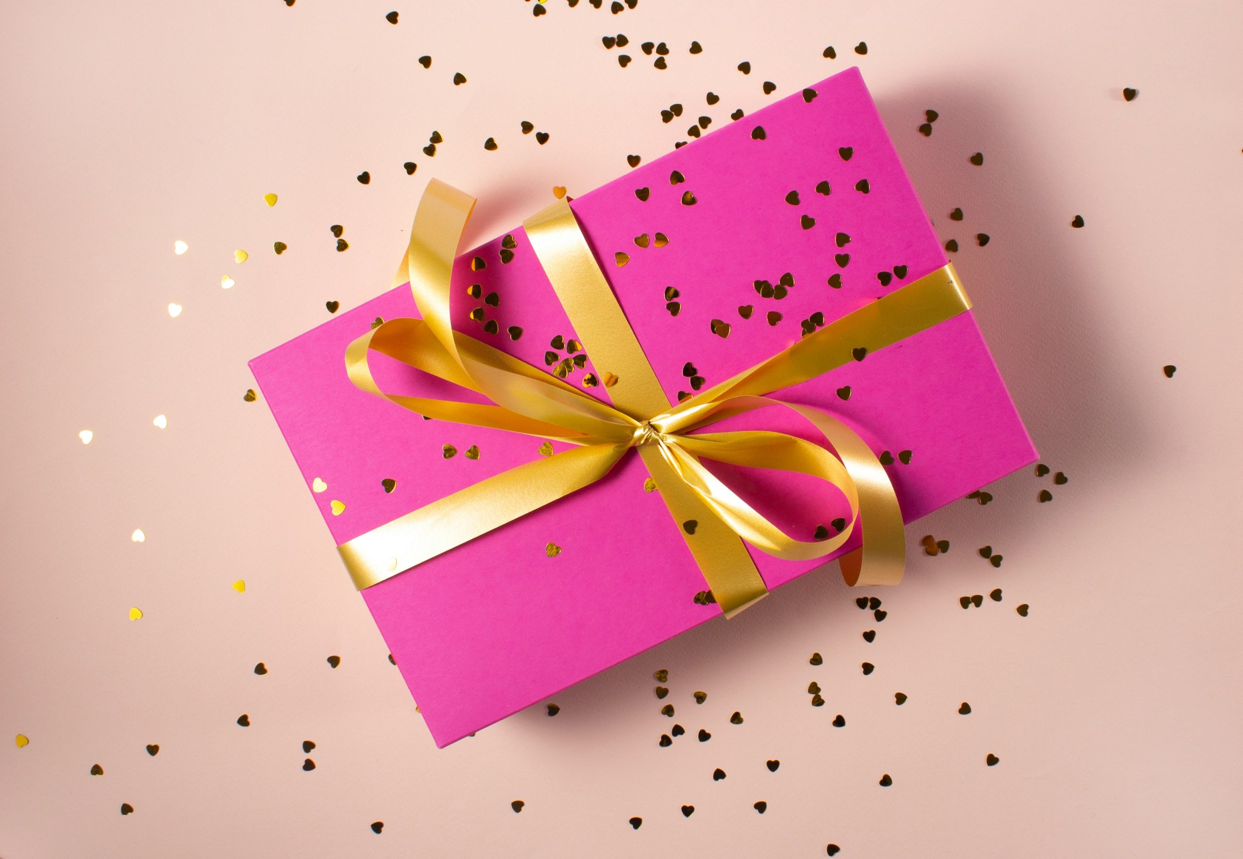 Gift card in a pink box with a gold bow